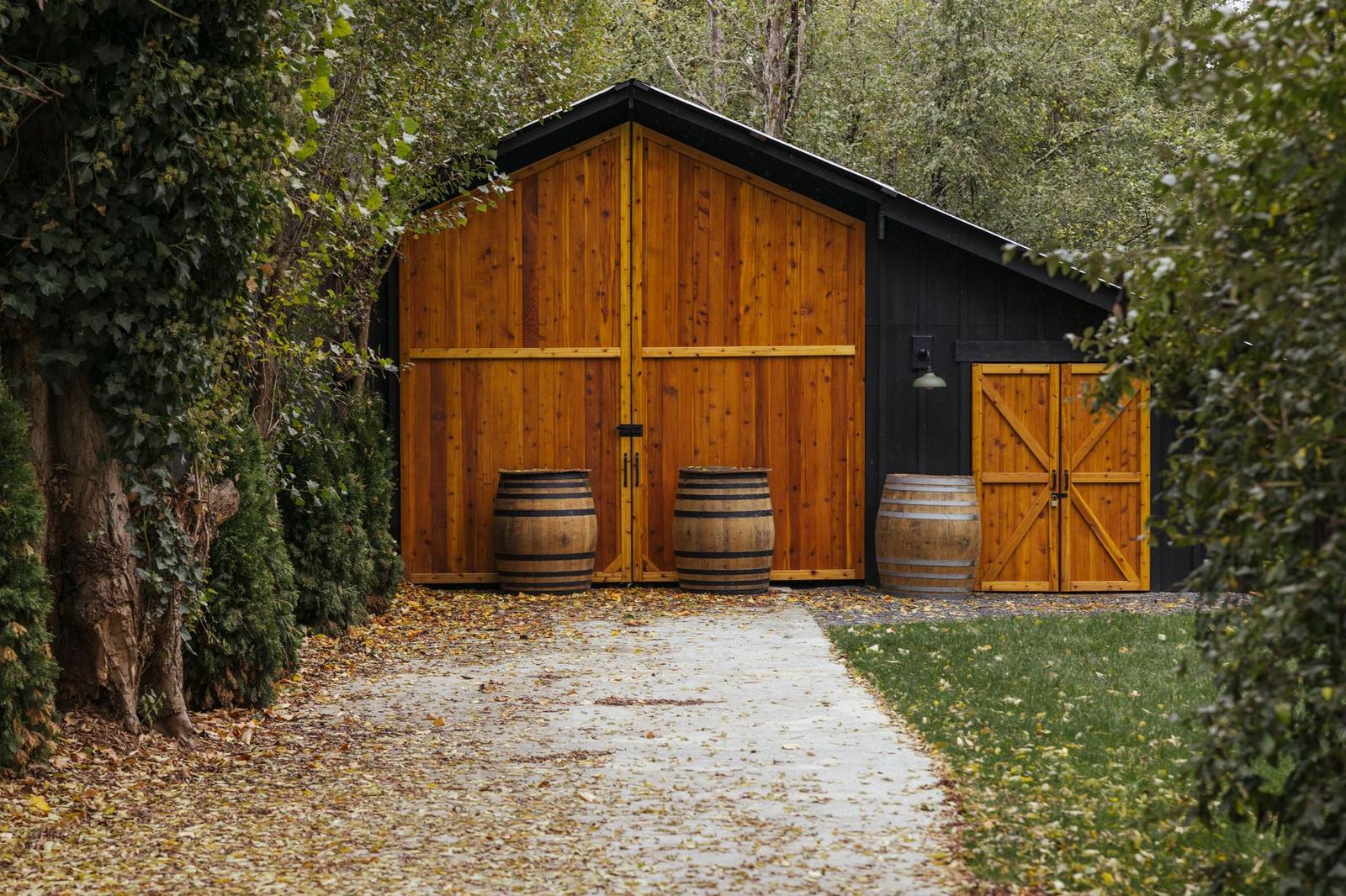 Restored barn with wine barrels outside a Stay Flourish-managed Bothell short-term rental at Mondok Cellars