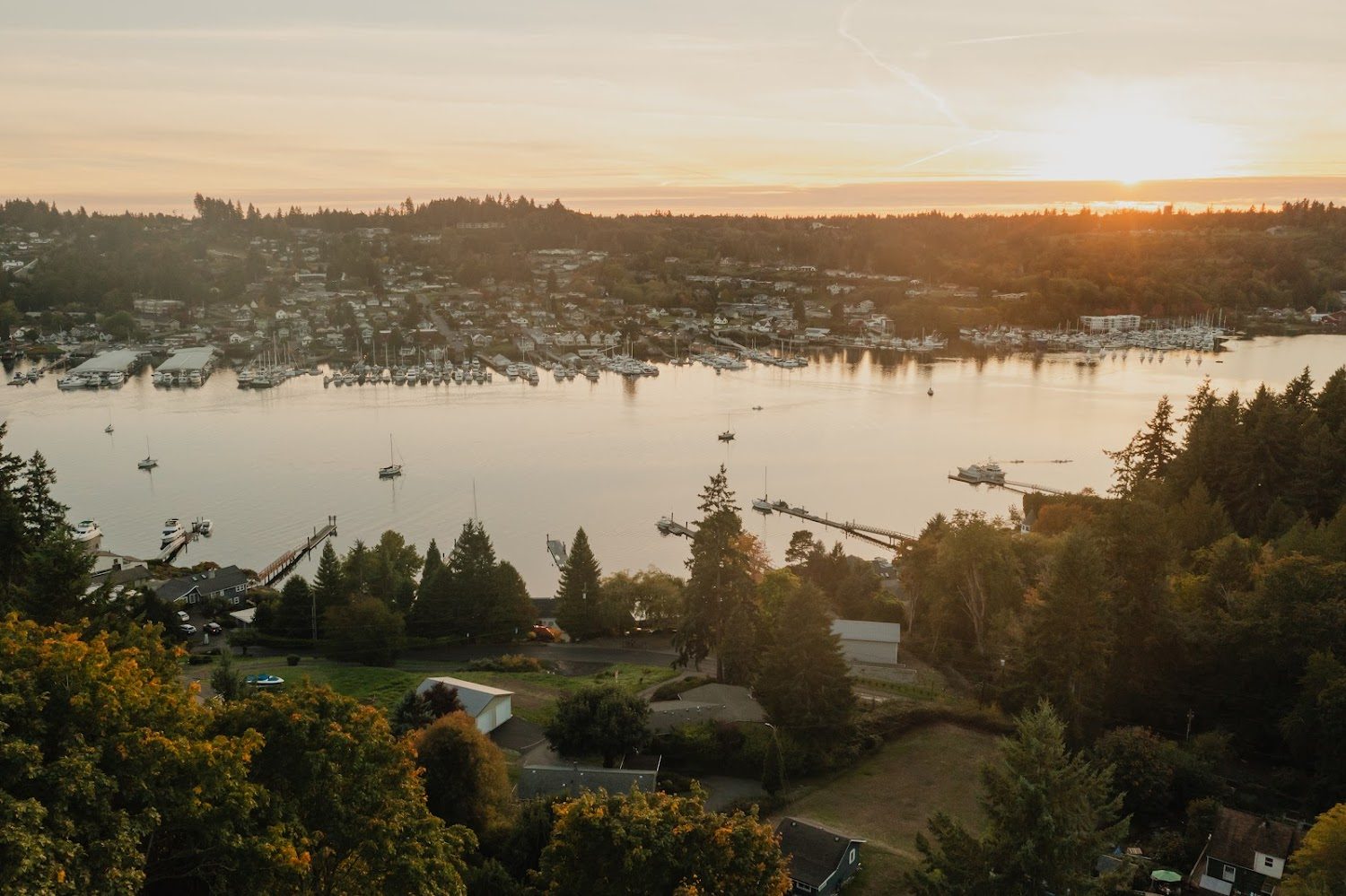 Aerial sunset view of a waterfront short-term rental home managed by Stay Flourish in the Puget Sound region